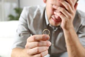 Sad husband experiencing divorce regret.